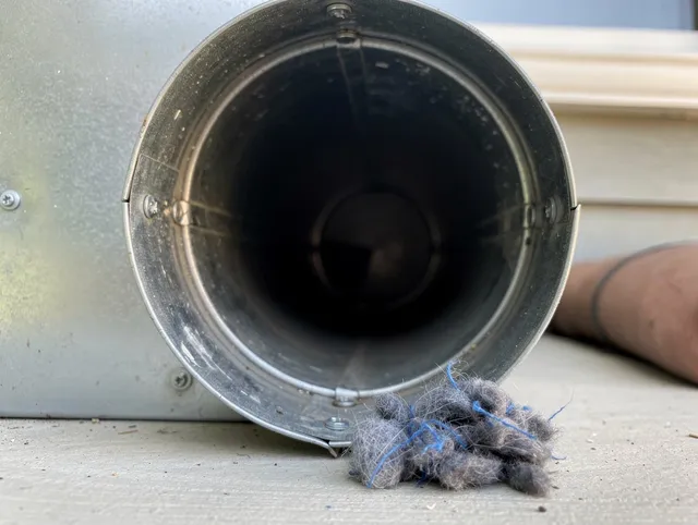 Seekonk Dryer Vent Cleaning technician using specialized equipment to clear severe dryer vent blockage in Seekonk